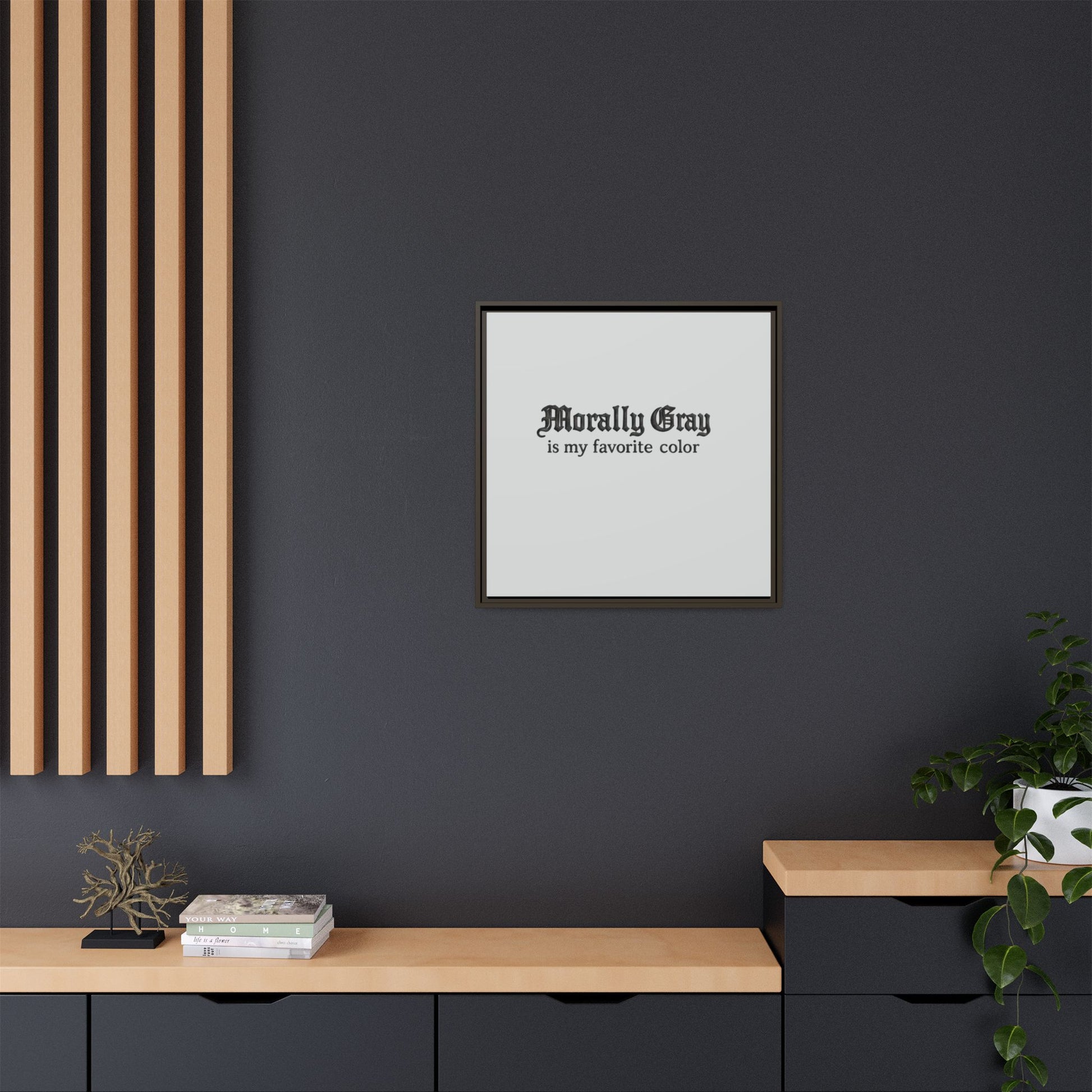 Framed wall art with the phrase "Morally Gray is my favorite color" displayed above a modern black and wood console in a minimalist room, featuring the Unknown Product.